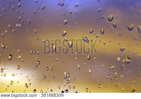 Beautiful Yellow Bright The Clouds During Sunset Or Sunrise, The Rain Drops On The Glass , Out Of Fo