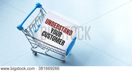 Shopping Cart And Text Udnerstand Your Customer On White Paper Note List. Shopping List Concept On B