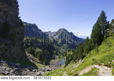 Small Green Lake In The Forest Under The Cliff