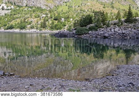Reflections At Sunrise On The Lake Lauvitel Shores