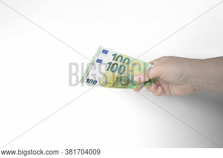 Closeup Of Outstretched Hand Holding Two Hundred Euro Bills Isolated On White Background.concept Of 