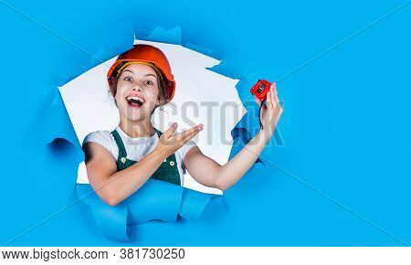 Happy Childhood. Self-retracting Metal Tape Measure. Little Girl Using A Measuring Tape. Constructio
