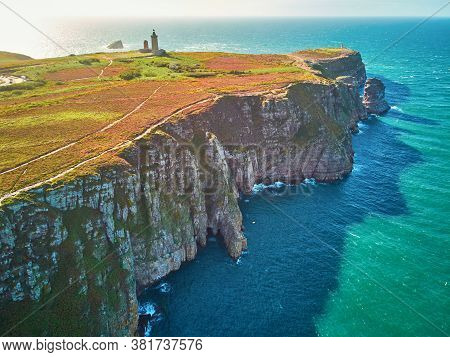 Scenic View Of Cape Frehel With Its Lighthouse, One Of The Most Popular Tourist Destinations In Brit