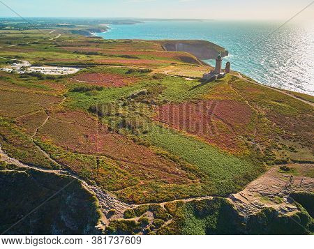 Scenic View Of Cape Frehel With Its Lighthouse, One Of The Most Popular Tourist Destinations In Brit