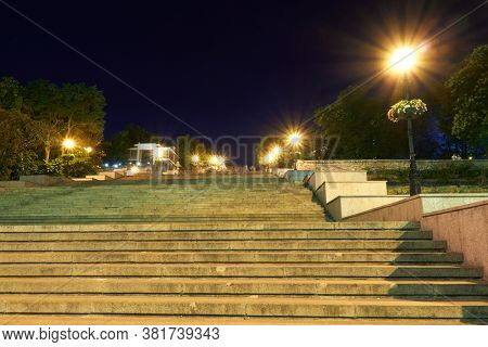 night street view of Odessa city, Ukraine, Potemkin stairs near the Primorskiy boulevard, walking people