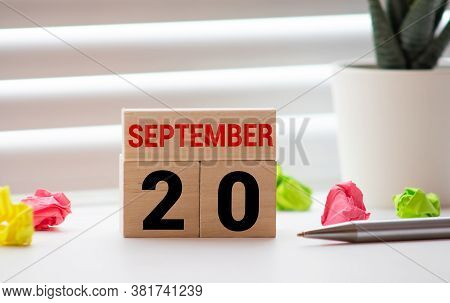 September 20st. Day 20 Of Month, Daily Calendar On White Table With Reflection, With Light Blue Back