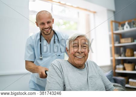 Senior Healthcare Caregiver And Happy Elder Patient