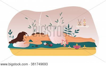 Woman Enjoying A Treatment At A Spa Or Beauty Salon Lying On A Couch Surrounded With Flowers, Candle