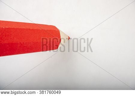 Red Pencil Stands On A White Background.