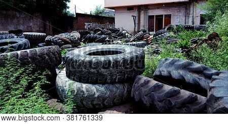 District Katni, India - August 03, 2019: Big Pile Of Automobile Tires On The Broken-down Plant. Many