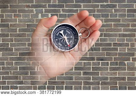 Abstract Photo With Compass In Hand On Brick Wall Background As Symbol Of Tourism With Compass, Trav