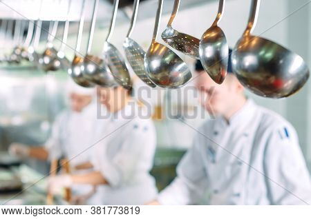 Modern Kitchen. Cooks Prepare Meals On The Stove In The Kitchen Of The Restaurant Or Hotel. The Fire