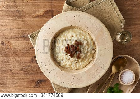 Risoto With Chanterelle Mushrooms In Large Plate. Traditional Italian Dish. Top View, Copy Space