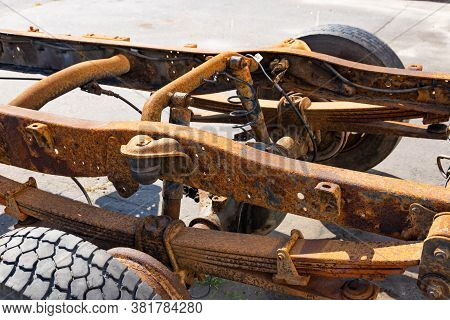 Old Rusty Car Frame, Shock Absorber, Truck Wheel.