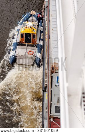 Szczecin, Poland - May 13, 2011: A Pilot Is Entering A Container Ship From His Pilot Boat For Naviga