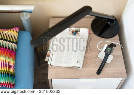 Ostfildern, Germany - May 21, 2015: An Apple Watch Is Being Loaded On The Bedside Table Using A Styl