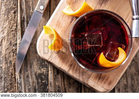 Boulevardier Cocktail And Orange Zest On Wooden Table. Top View