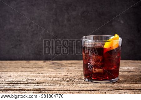 Boulevardier Cocktail And Orange Zest On Wooden Table.copy Space