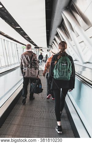 Gatwick, Uk - May 14, 2019: Passengers On Moving Walkway In The Terminal Of Gatwick Airport. Concept
