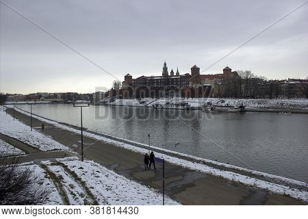 Krakow, Poland - January 29, 2015: Wide Angle View Of Famous Wawel Castle Covered With Snow Next To 
