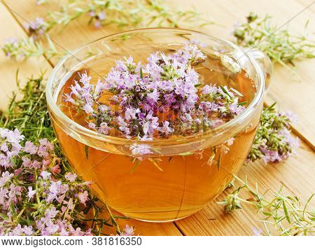 Cup Of Thyme Chaber Tea On White Wooden Background.shallow Dof.