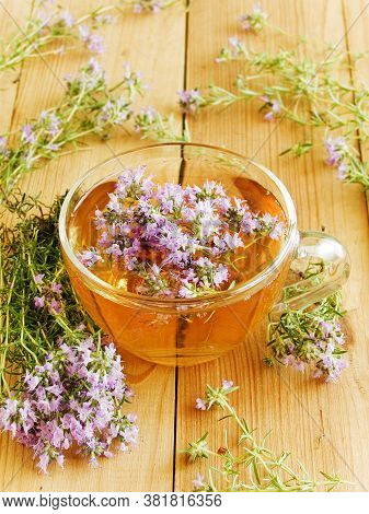 Cup Of Thyme Chaber Tea On White Wooden Background.shallow Dof.