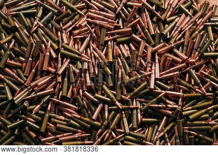 A Lot Of Different Ammo On A Wooden Background.