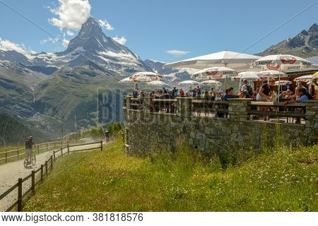 People Eating On The Restaurant Of Sunnegga Over Zermatt In The Swiss Alps