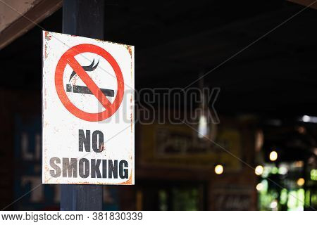 Close Up Of A Grunge Rustry No Smoking Sign, Outdoor Infront Of A Restaurant Background, Selective F