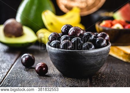 Jaboticaba Or Jabuticaba, Brazilian And South American Fruit, In A Clay Pot. With Tropical Fruits In
