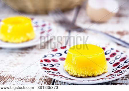 Egg Yolk Candy, Called Quindim In Brazil, And Portugal In Brisa-do-lis. Sweet Dessert On Rustic Wood