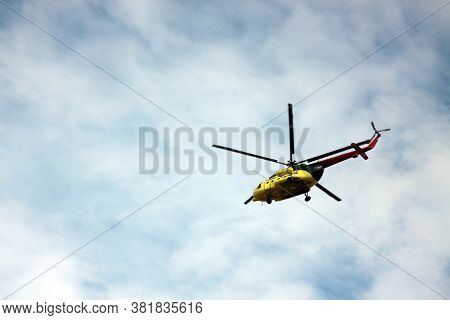 Medevac Helicopter Flying In Blue Cloudy Sky. Image Contains Copy Space. Horizontal Image