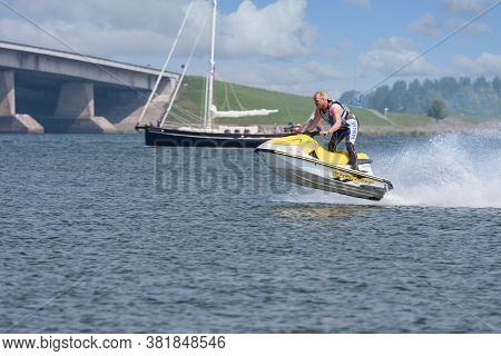 Lelystad, The Netherlands- May 01, 2009: Man Having Fun On Jet Ski Jumping On Waves Near Dutch Ketel