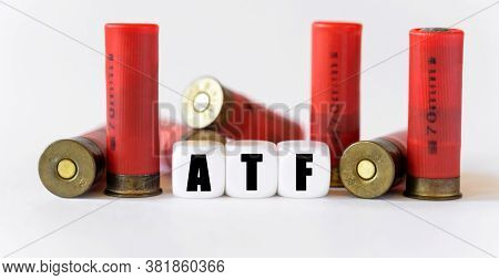 Against The Background Of Rifle Cartridges, There Are White Cubes With Text Atf. Hunting And Danger 