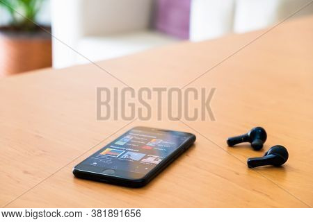 Bangkok Thailand 14 Aug 2020. Smartphone Device On Top Of The Wood Table Open Spotify Music Streamin