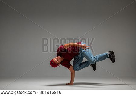 Cool Guy Breakdancer Dancing Lower Break Dance On The Floor Isolated On Gray Background. Break Dance