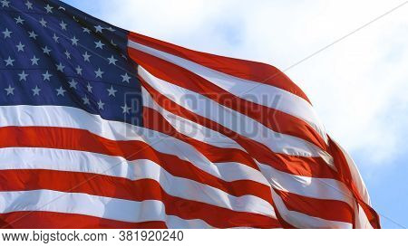 American Flag Waving Proudly In The Wind, Representing. United States Of America On A Sunny Day. Usa