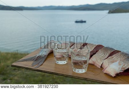Glasses With Poured Vodka And Sliced Fish.
