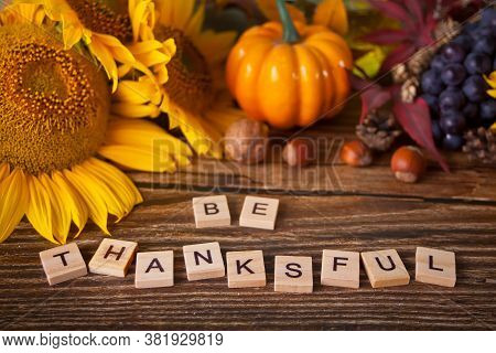Greeting Card With Be Thanksful Text. Composition With Pumpkin, Autumn Leaves And Berries. Cozy Autu