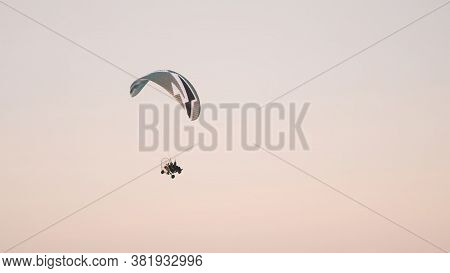 Paramotor Tandem Gliding And Flying In The Air. Copy Space. High Quality Photo