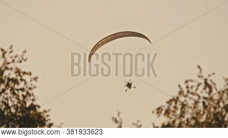 Paramotor Tandem Gliding And Flying In The Air. Copy Space. High Quality Photo