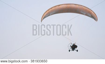 Paramotor Tandem Gliding And Flying In The Air. Copy Space. High Quality Photo
