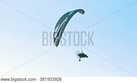 Paramotor Tandem Gliding And Flying In The Air. Copy Space. High Quality Photo