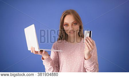 Young Caucasian Woman With Big Smile Holding Laptop And Credit Card. Online Shopping Concept. High Q
