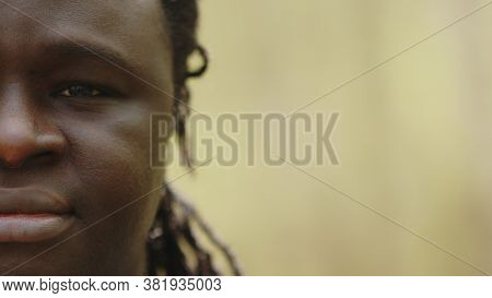 Half Face Of An African Crying Black Man With A Tear In The Eye. High Quality Photo