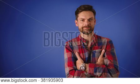 Handsome Caucasian Man With Crossed Arms Smiling Isolated On The Blue Background. High Quality 4k Fo