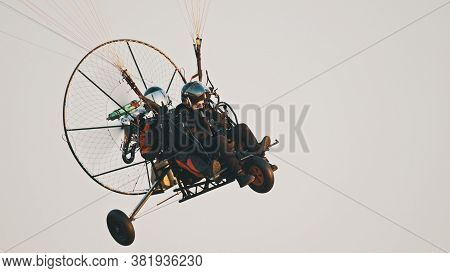 Paramotor Tandem Gliding And Flying In The Air. Copy Space. High Quality Photo