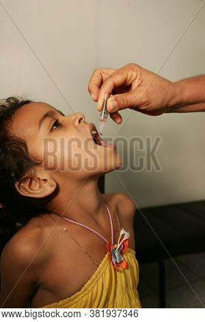 Eunapolis, Bahia / Brazil - August 14, 2010: Child Seen Receiving Dose Of Polio Vaccine At Health Po