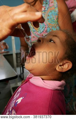 Eunapolis, Bahia / Brazil - August 14, 2010: Child Seen Receiving Dose Of Polio Vaccine At Health Po