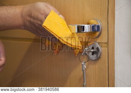 Cleaning The Door Handle For Coronavirus Prevention During Normal New Quarantine